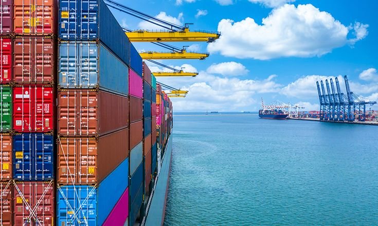 Containers unloaded by cranes at a deep sea port