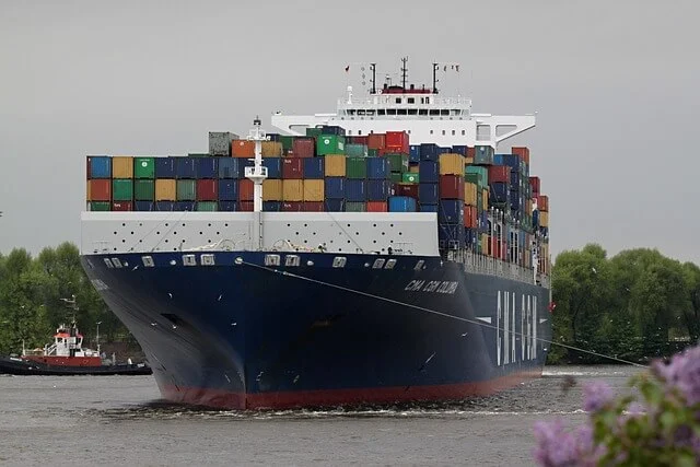Container ship berthed under gantry cranes